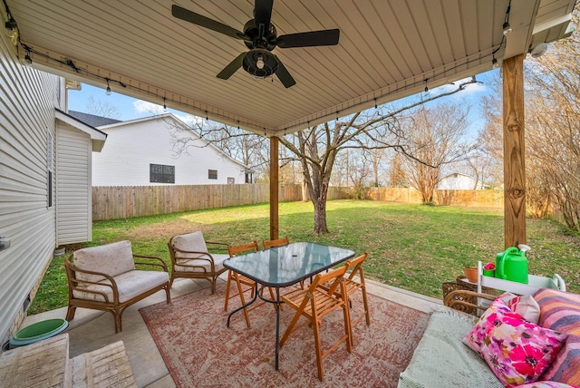 view of patio / terrace featuring outdoor dining space, a ceiling fan, and a fenced backyard