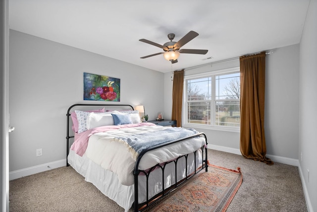 carpeted bedroom featuring a ceiling fan, baseboards, and visible vents