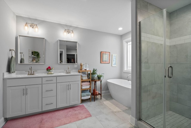 bathroom featuring a sink, double vanity, a shower stall, and tile patterned floors