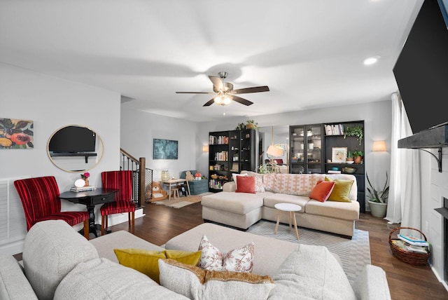 living area featuring ceiling fan, stairway, wood finished floors, and recessed lighting