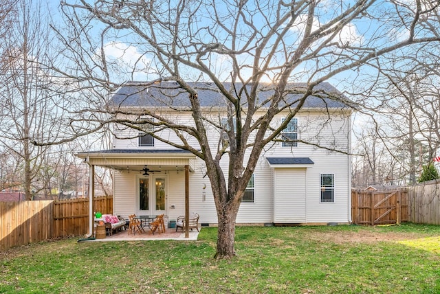 back of house with a patio area, a fenced backyard, a lawn, and a ceiling fan