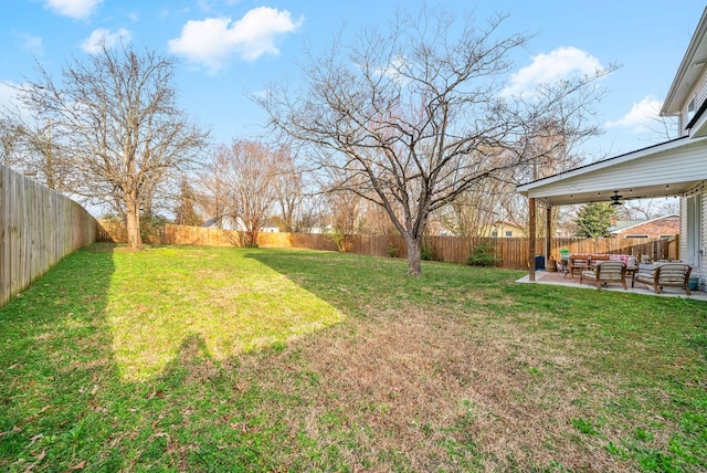 view of yard featuring an outdoor living space, a ceiling fan, a fenced backyard, and a patio