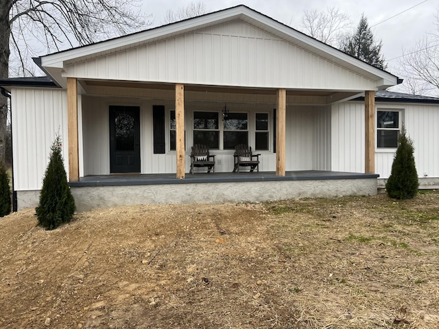 back of property with a porch