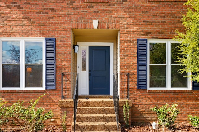 property entrance with brick siding