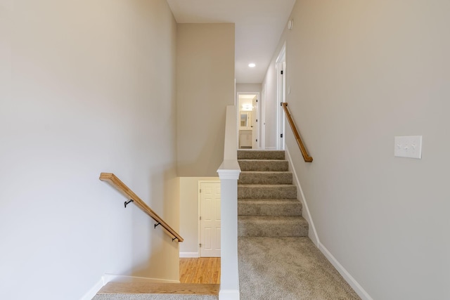 staircase with recessed lighting and baseboards