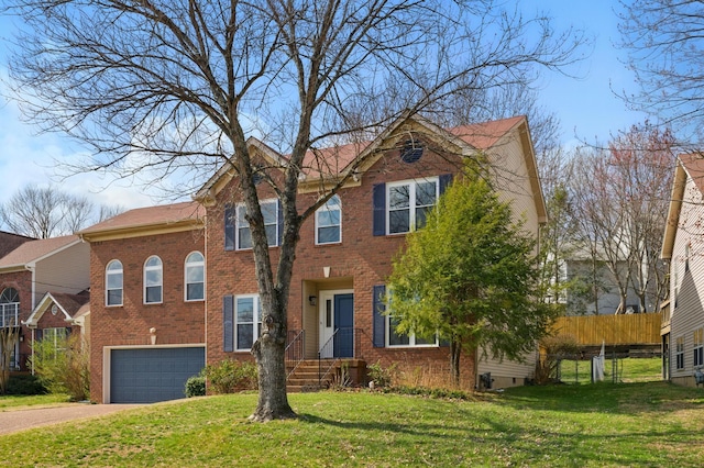 view of front of home with brick siding, an attached garage, a front lawn, fence, and driveway