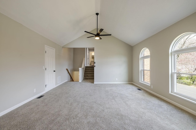 empty room featuring a ceiling fan, visible vents, carpet floors, and baseboards