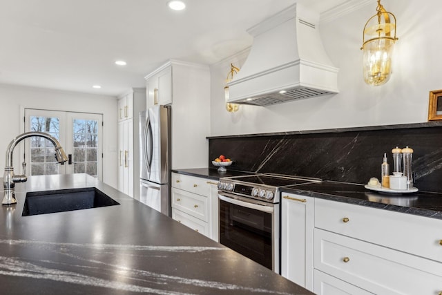 kitchen with tasteful backsplash, custom range hood, white cabinets, stainless steel appliances, and a sink