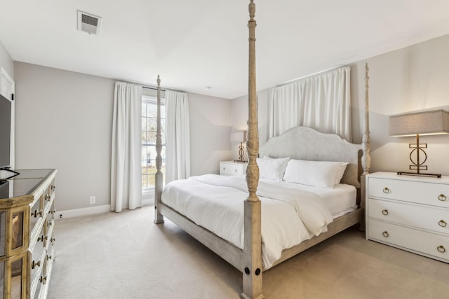 bedroom with light carpet, visible vents, and baseboards