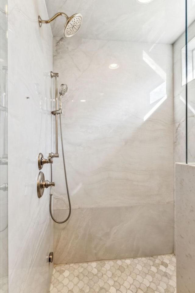 full bathroom with a marble finish shower