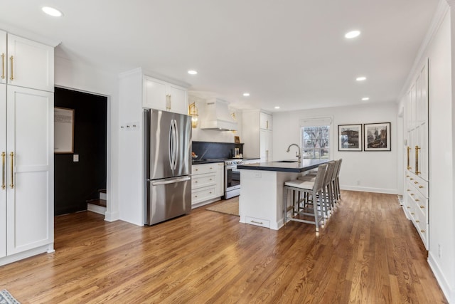 kitchen with dark countertops, white cabinetry, stainless steel appliances, and custom exhaust hood