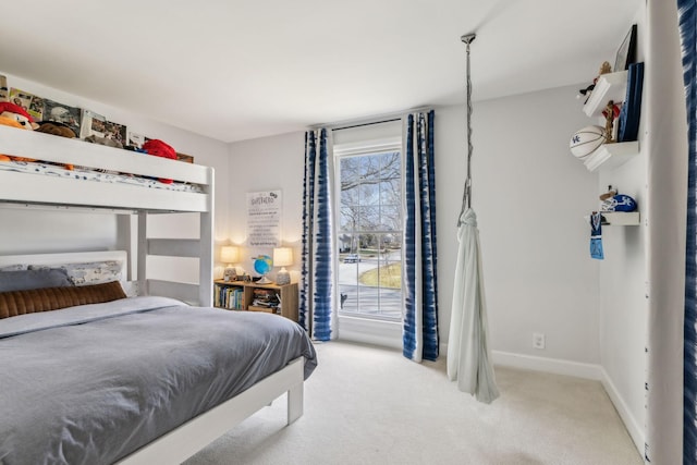 carpeted bedroom with baseboards and access to outside