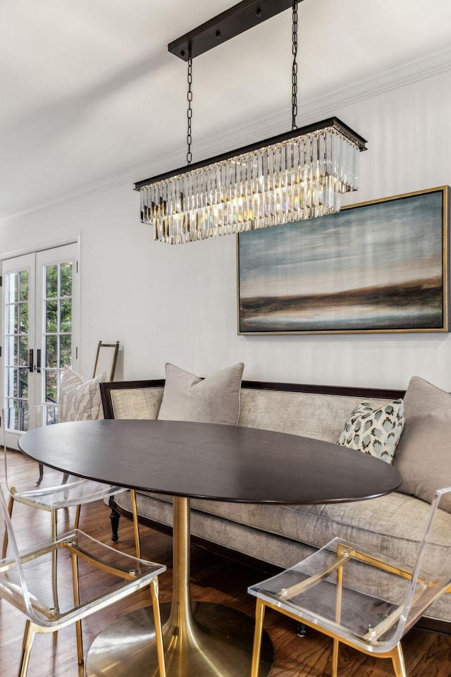 dining area featuring french doors, wood finished floors, and crown molding