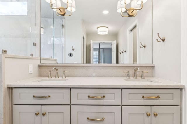 full bathroom featuring a sink, a notable chandelier, and double vanity