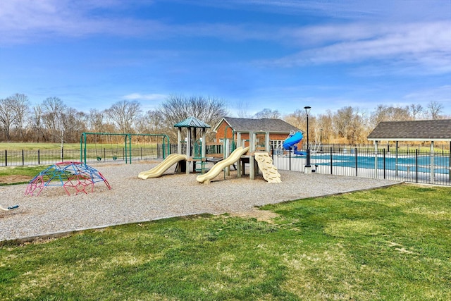 communal playground with a lawn and fence