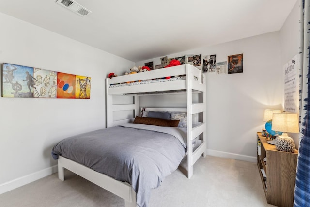 carpeted bedroom with visible vents and baseboards