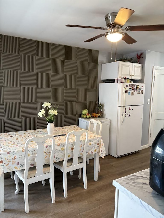 dining room featuring a ceiling fan and wood finished floors