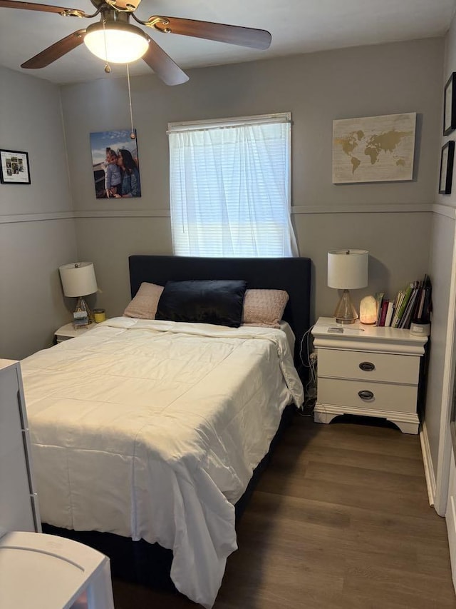 bedroom featuring a ceiling fan and wood finished floors