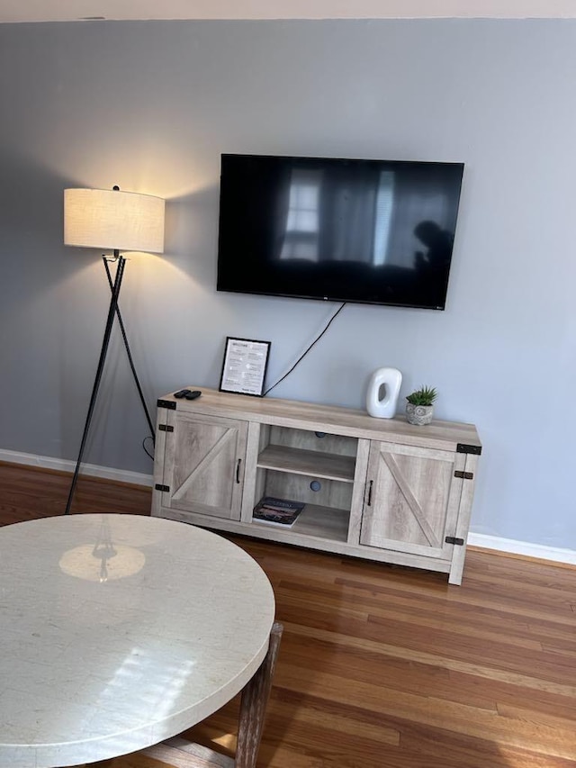 room details featuring baseboards and wood finished floors