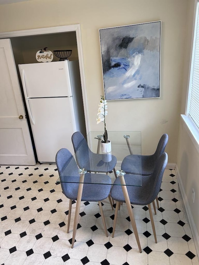 dining room featuring light tile patterned floors and baseboards