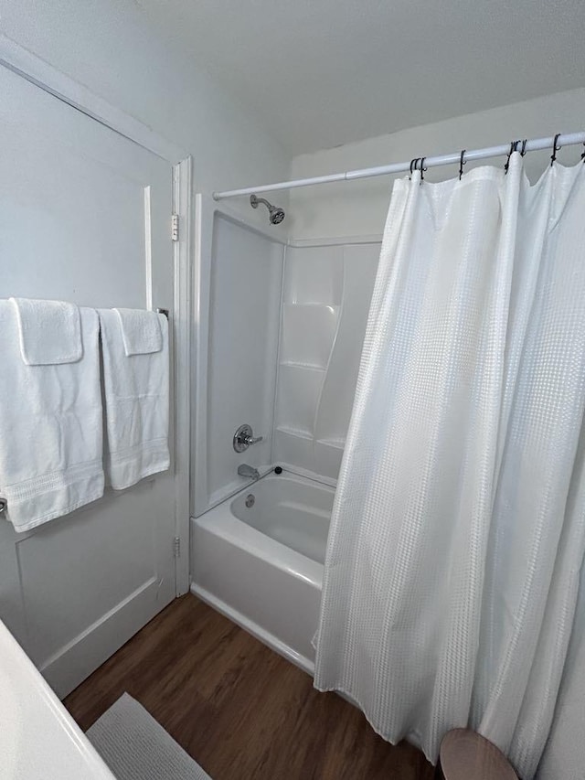 full bathroom with shower / tub combo with curtain and wood finished floors