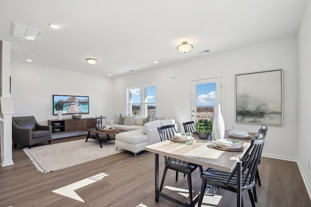 dining area featuring baseboards, wood finished floors, visible vents, and recessed lighting