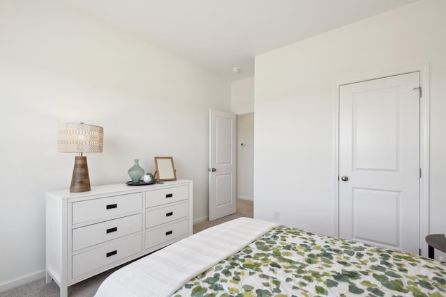 carpeted bedroom featuring baseboards