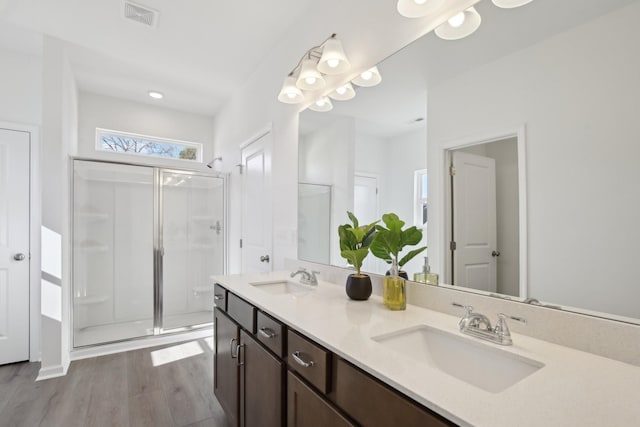 full bath with a shower stall, visible vents, and a sink