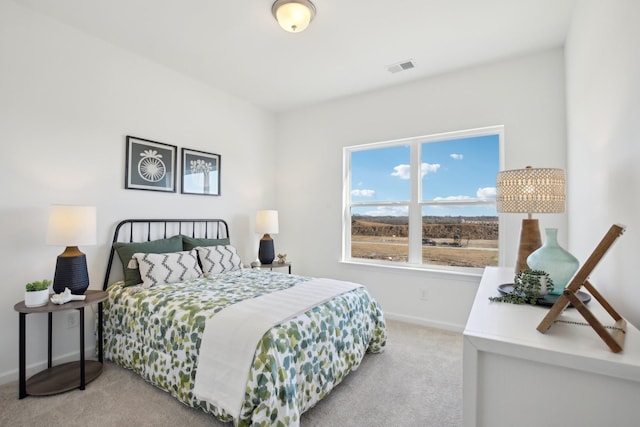 bedroom with visible vents, baseboards, and carpet
