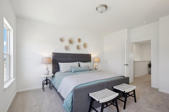carpeted bedroom with baseboards and multiple windows