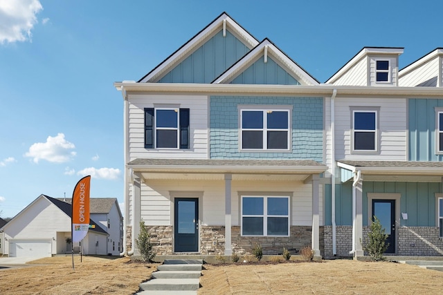 view of front of house with stone siding and board and batten siding
