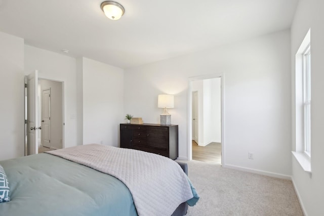 bedroom with baseboards and carpet