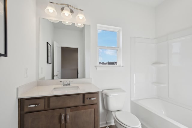 bathroom with baseboards, vanity, and toilet