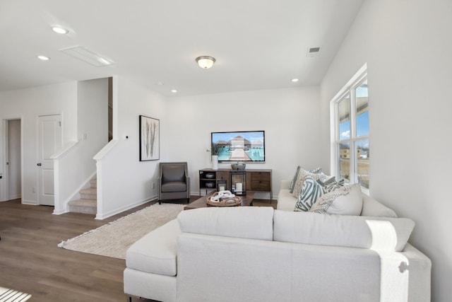 living room with wood finished floors, visible vents, recessed lighting, and stairway