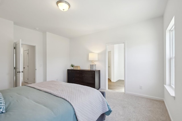 bedroom featuring baseboards and carpet