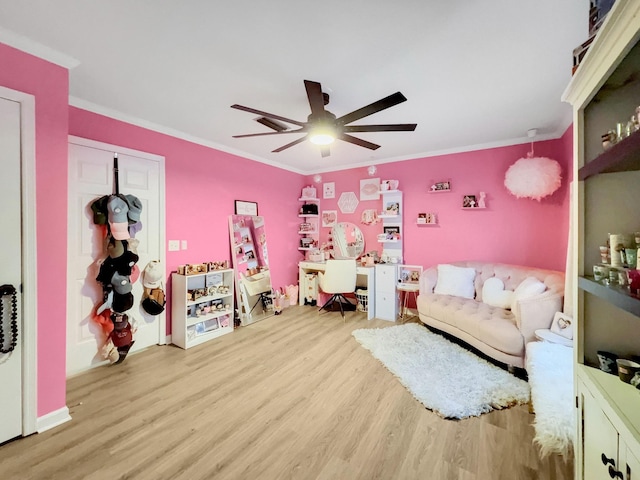 interior space featuring light wood-type flooring, crown molding, and ceiling fan