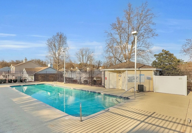 community pool featuring a patio and fence