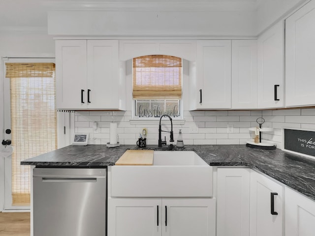 kitchen with a sink, white cabinetry, decorative backsplash, and stainless steel dishwasher