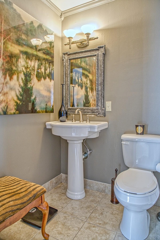 bathroom featuring tile patterned floors, toilet, baseboards, and ornamental molding