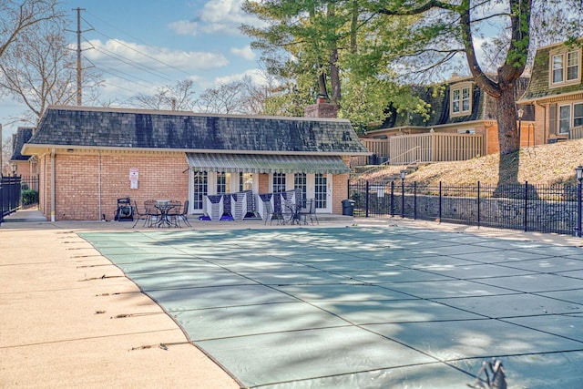 exterior space featuring a patio, fence, and brick siding