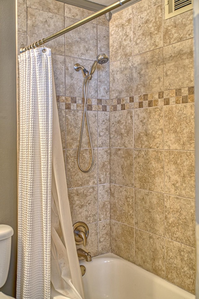 full bath featuring shower / bath combo with shower curtain and toilet