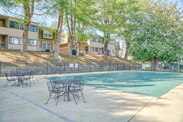 view of pool with a patio and fence