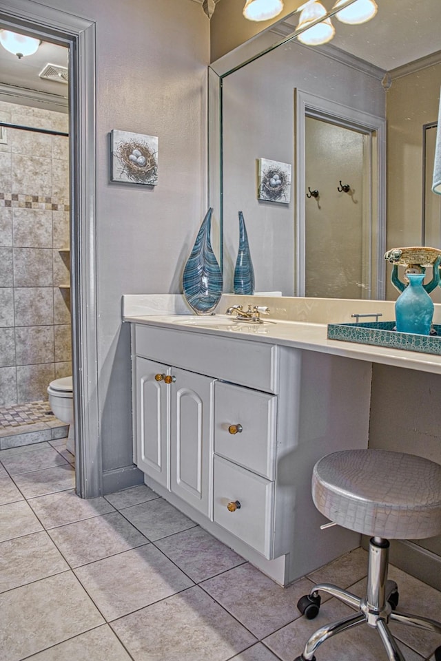 full bathroom featuring vanity, tile patterned floors, toilet, and a tile shower