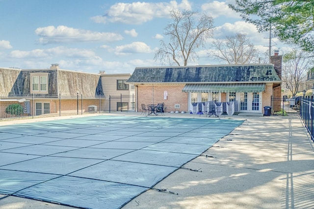 community pool featuring a patio and fence