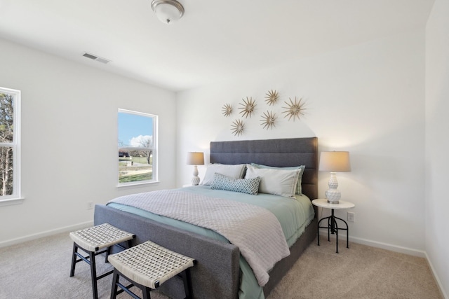 carpeted bedroom with baseboards and visible vents