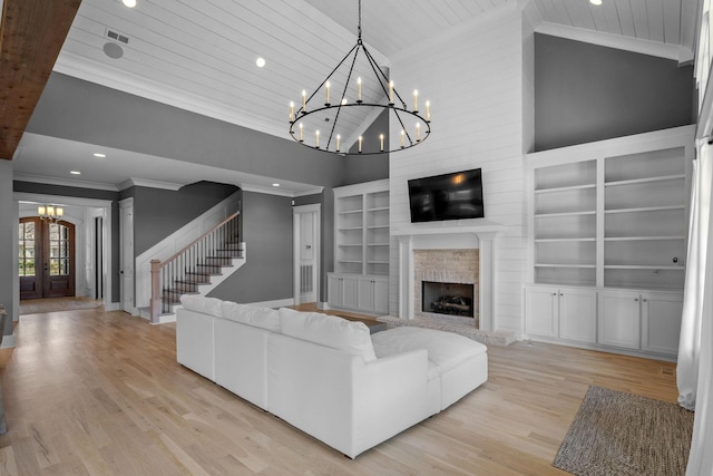 unfurnished living room featuring built in features, wood ceiling, crown molding, and an inviting chandelier