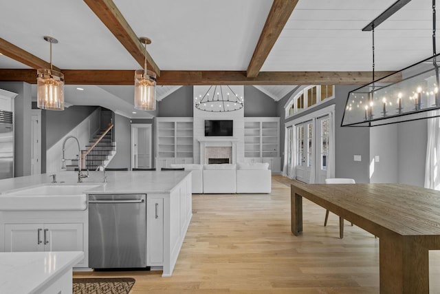 kitchen featuring dishwasher, lofted ceiling with beams, an inviting chandelier, white cabinetry, and a sink