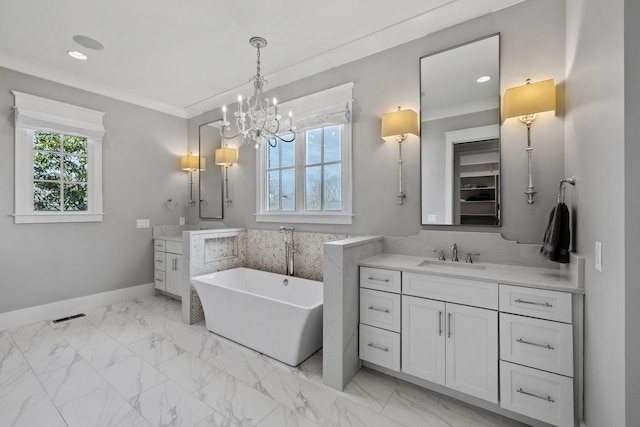 bathroom with marble finish floor, two vanities, a sink, crown molding, and a chandelier