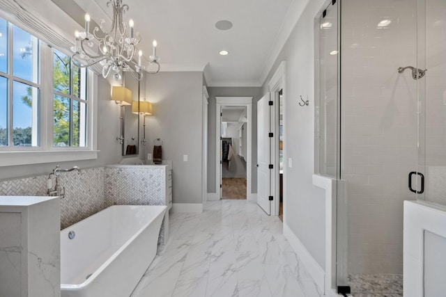 bathroom with baseboards, a soaking tub, ornamental molding, a shower stall, and marble finish floor