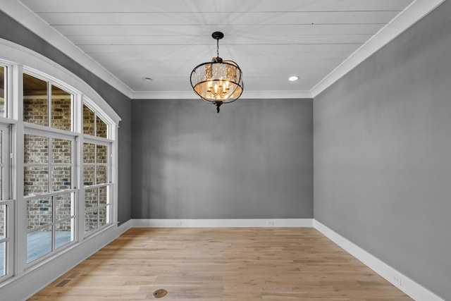 unfurnished dining area with visible vents, baseboards, an inviting chandelier, and ornamental molding